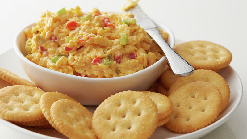 Pimiento Cheese prepared recipe in a bowl surrounded by a plate of crackers