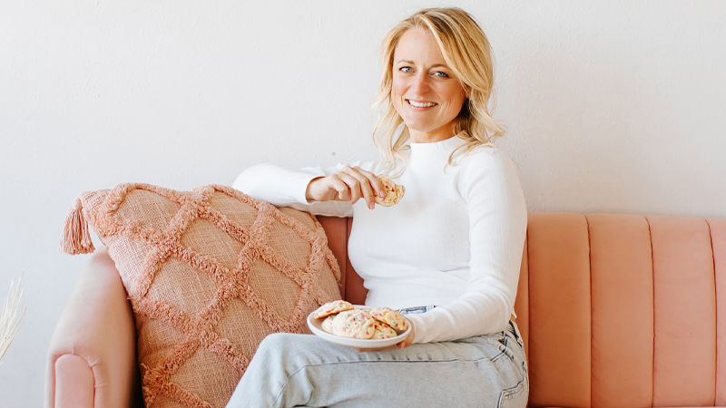 Haley Williams sitting on a couch holding a plate of cookies